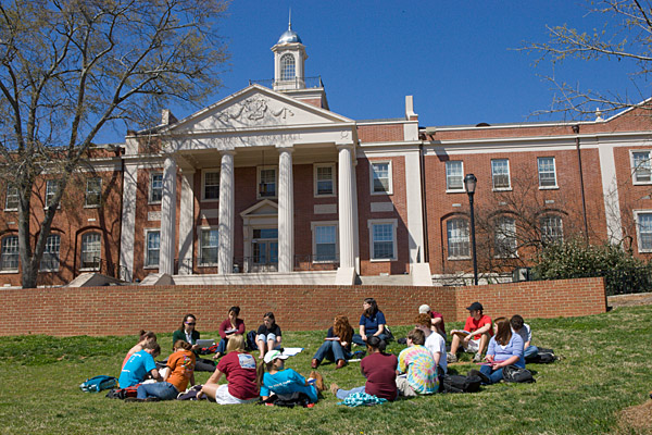 Students study on the lawn in front of Park Hall