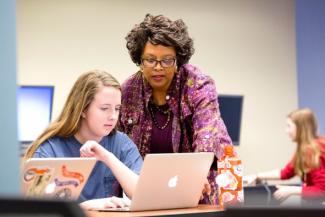 Barbara McCaskill helps English major Laura Essex with a project during her literary magazine editing class. Photo by Dorothy Kozlowski