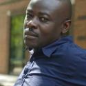 Picture of author Helon Habila sitting outside